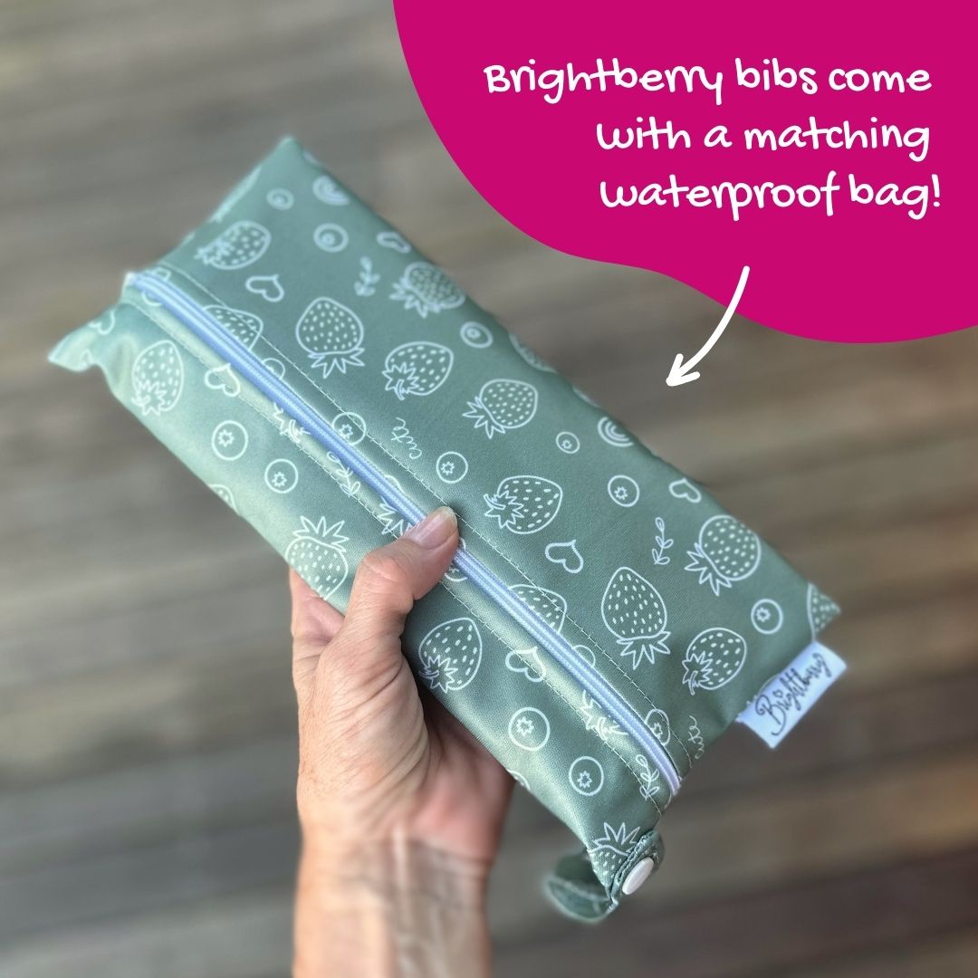 hand holding Brightberry bib packed in a waterproof carry bag